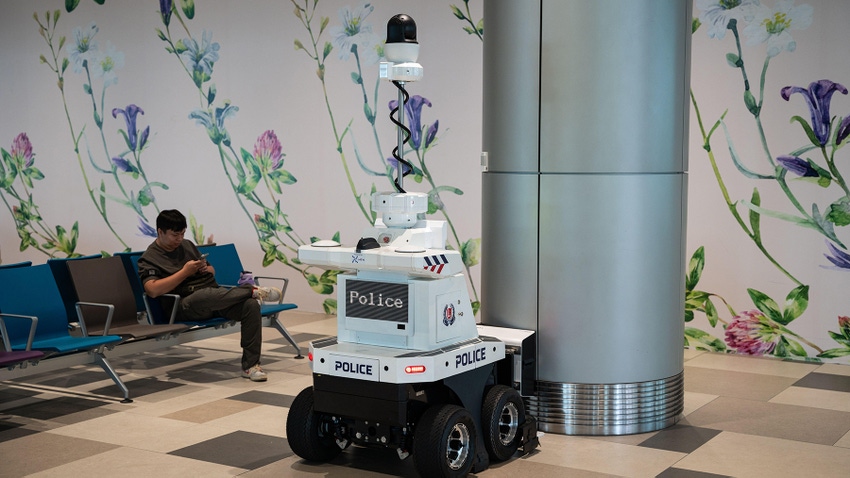 A fully automated police robot stands at a charging station in Terminal T4 at Singapore Changi International Airport