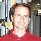 Lee Sattler, Distinguished Engineer in Product Strategy and Operations at Verizon, has light brown short hair and brown eyes
