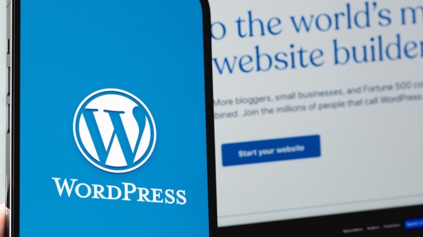 WordPress logo on a mobile device screen next to the homescreen of its website on a laptop screen