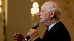Senator Ben Cardin speaking into a microphone Senator Ben Cardin speaking into a microphone
