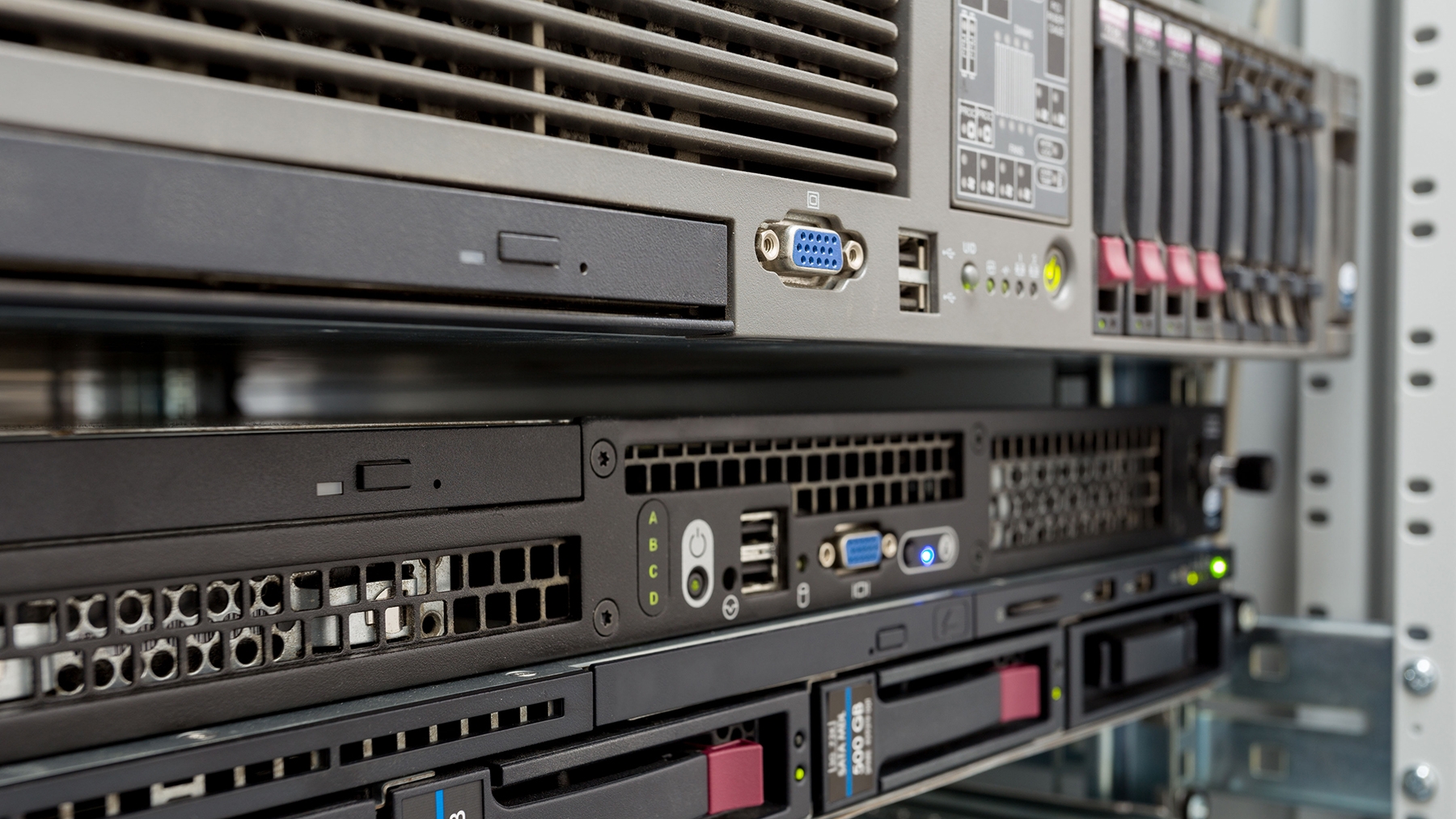 Stack of servers with hard drives and tape drives in a datacenter for backup and data storage