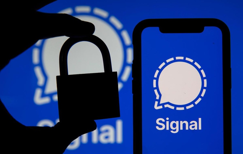 Image of a hand and a padlock signifying security -- in the foreground of a Signal messaging app