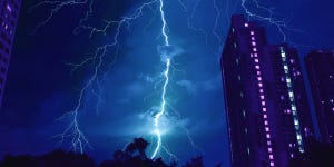 Pop art surreal photo of incredible lightning strikes in cobalt blue city night sky