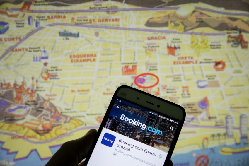 Booking.com app on a mobile phone with map in the background