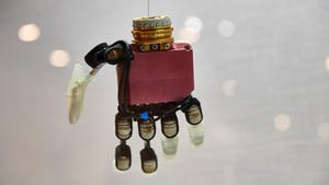 Robot version of a human hand hangs in a display case in Dortmund art exhibition; photo by Bernd Thissen