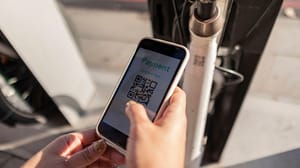 A person holding a phone, scanning a QR code A person holding a phone, scanning a QR code