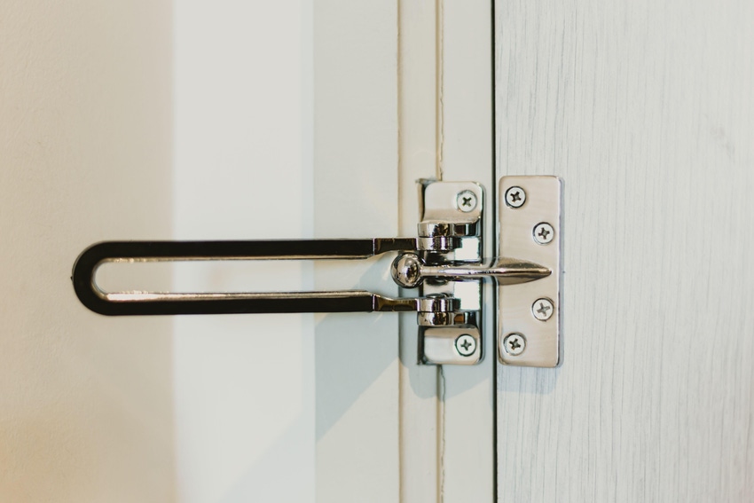 Photo of a hotel room swing bar door lock.