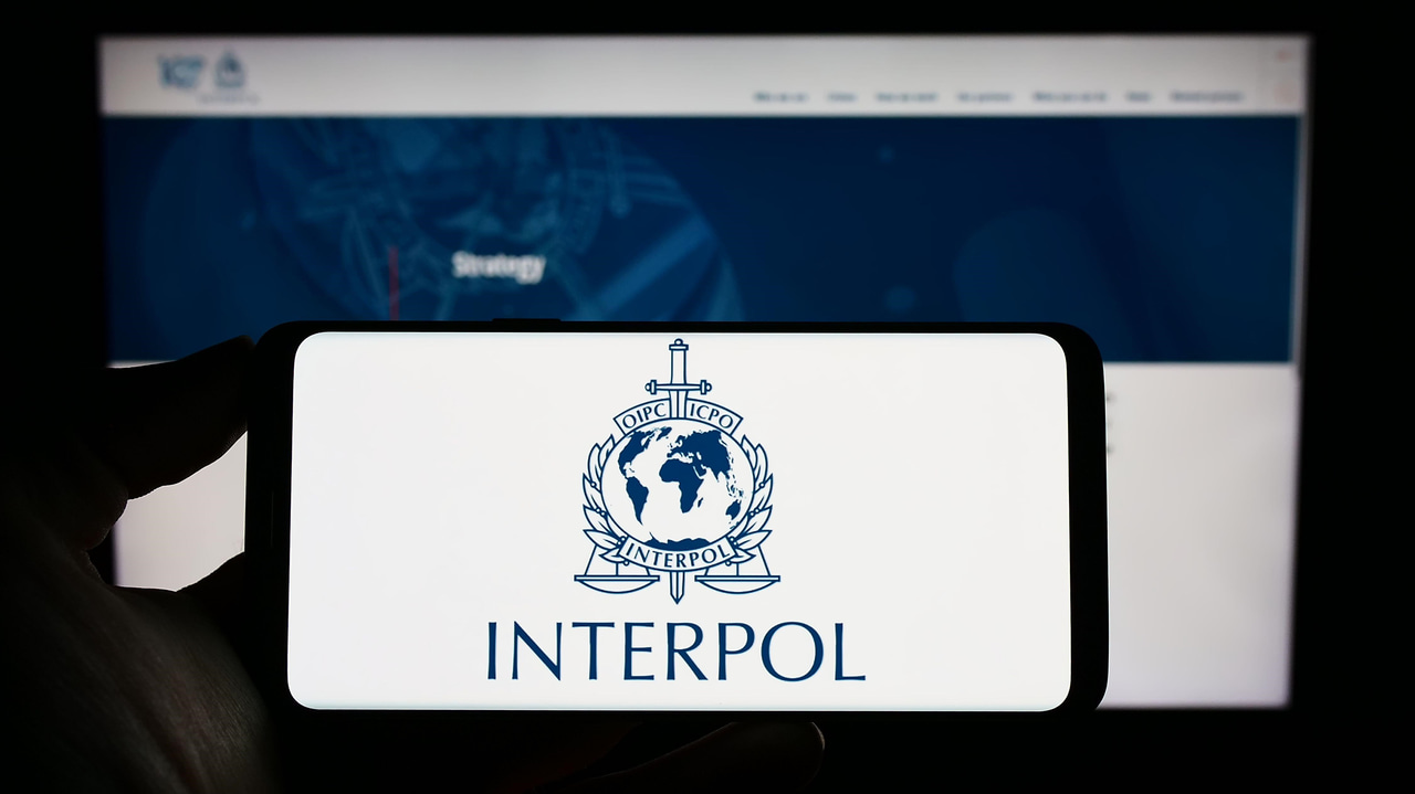 Interpol logo displayed on mobile phone screen Interpol logo displayed on mobile phone screen