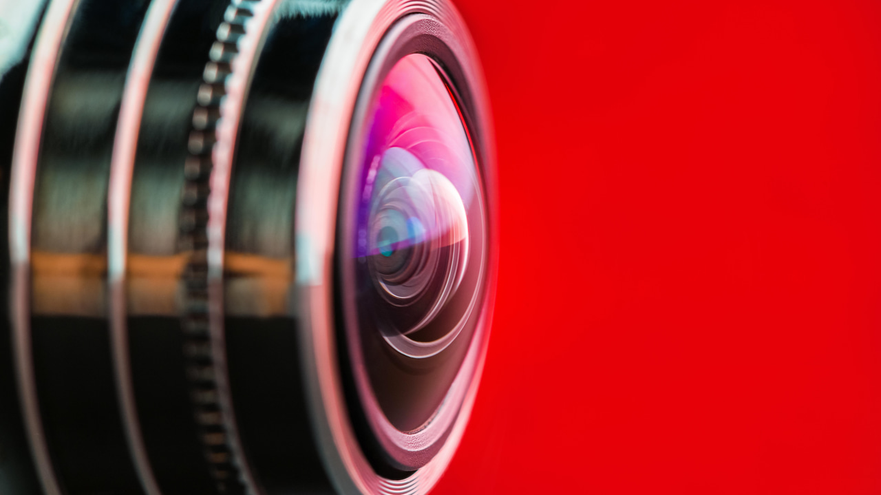 A camera lens on red background A camera lens on red background