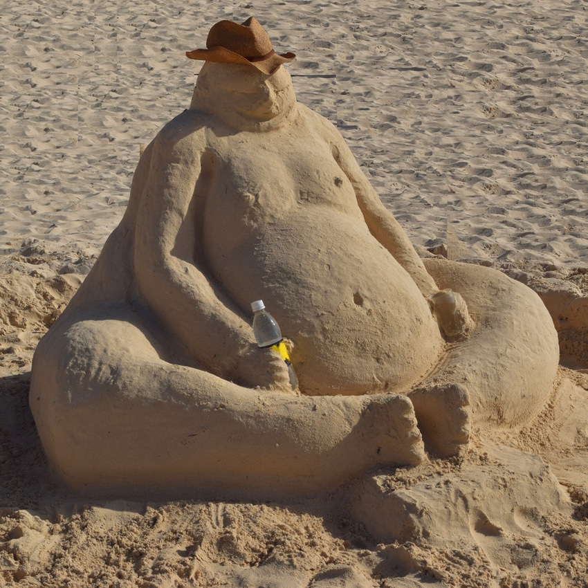 Sandman holding a bottle in the beach