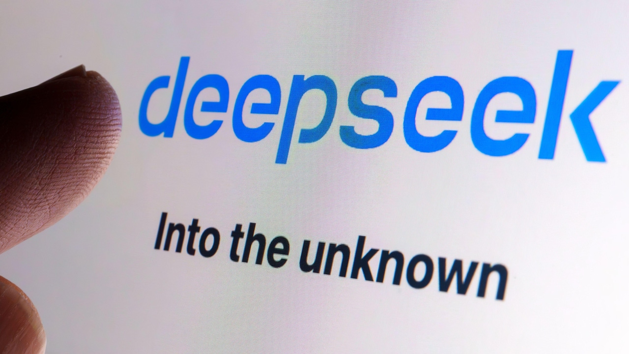 Human finger pointing to the word "deepseek" in blue on a computer screen with the words "into the unknown" under it Human finger pointing to the word "deepseek" in blue on a computer screen with the words "into the unknown" under it