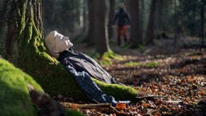 Resuscitation training dummy lying against tree during intensive wilderness first aid course in Europe
