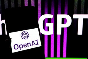 A phone with the OpenAI logo onscreen in front of a background featuring the letters GPT on black and purple stripes