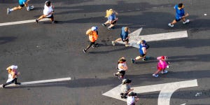 Runners in a marathon running in the opposite direction of what the rules say.