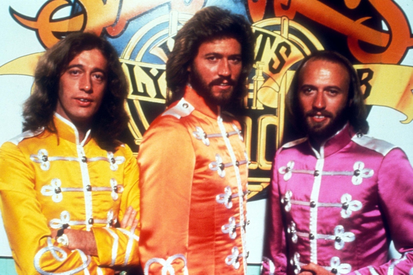 Three men in colorful clothing standing beside each other