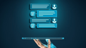 A hand holding a laptop computer underneath icons and boxes showing chatbot interactions on top A hand holding a laptop computer underneath icons and boxes showing chatbot interactions on top