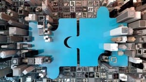 Two blue puzzle pieces joining together in a cityscape setting. Two blue puzzle pieces joining together in a cityscape setting.