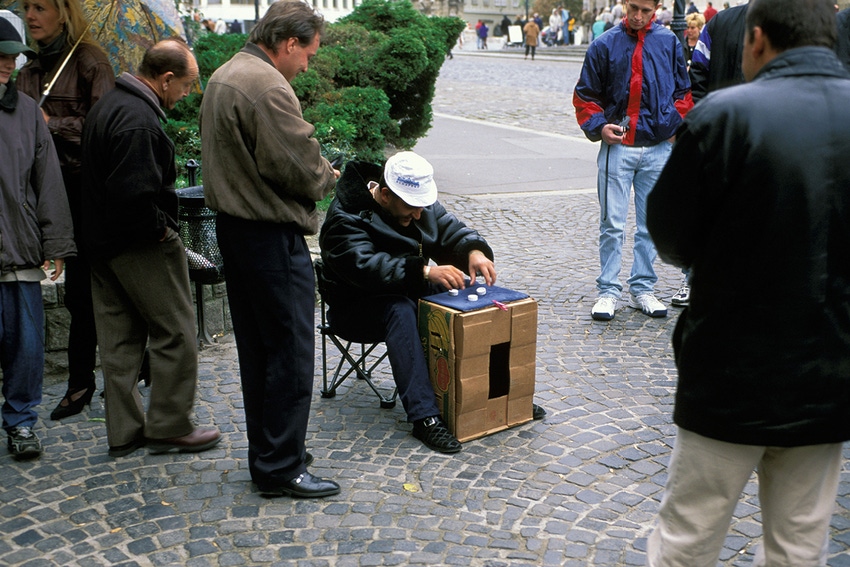 Budapest scam artists trying to involve passersby in illegal street game of find-the-ball on overturned wooden crate