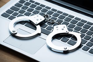 Closeup of handcuffs on laptop