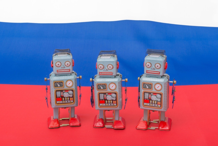 Wind-up robot toys over Russian flag background