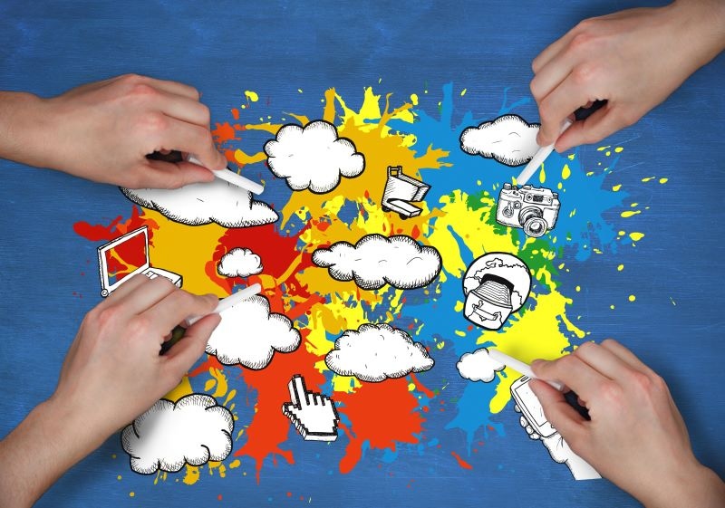 Photo depicting a multicloud strategy, with four hands drawing the concept with chalk.
