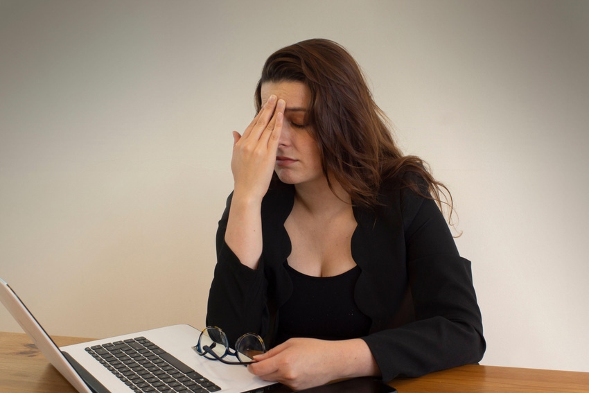 Woman at desk tired from work
