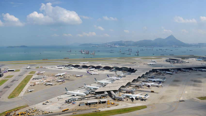 Aerial view of Hong Kong International Airport and the harbor and mountain beyond