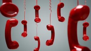 several red landline phone receivers dangling from their cords