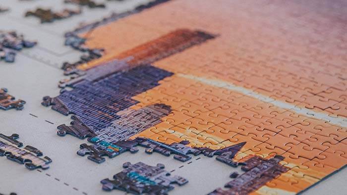 Incomplete jigsaw puzzle of a city skyline.