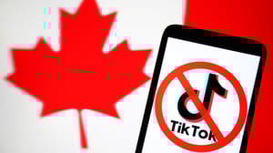 A crossed out TikTok logo on a phone screen in front of a Canadian flag A crossed out TikTok logo on a phone screen in front of a Canadian flag