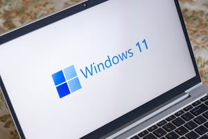 Windows 11 logo on laptop screen stock image.