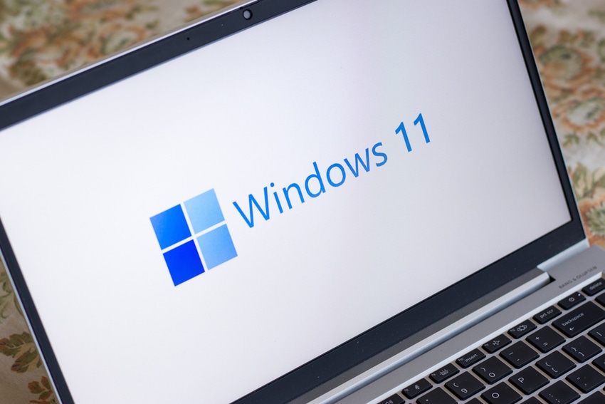 Windows 11 logo on laptop screen stock image.