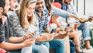 Multicultural people group using smartphone with coffee at university college campus Multicultural people group using smartphone with coffee at university college campus