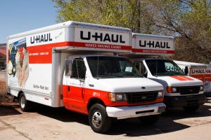 Two U-Haul trucks in a driveway