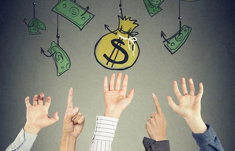 Hands reaching for money Hands reaching for money