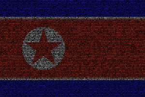 North korean flag composed of dense computer code cybersecurity programming concept