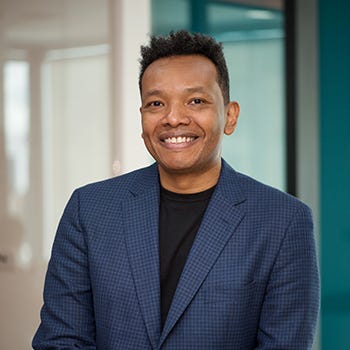 Ricardo Villadiego has dark eyes and hair, and he's wearing a black t-shirt under a blue blazer Ricardo Villadiego has dark eyes and hair, and he's wearing a black t-shirt under a blue blazer
