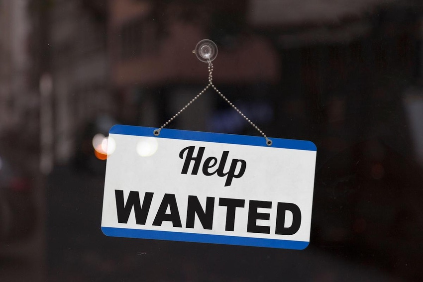 A help wanted sign on a window