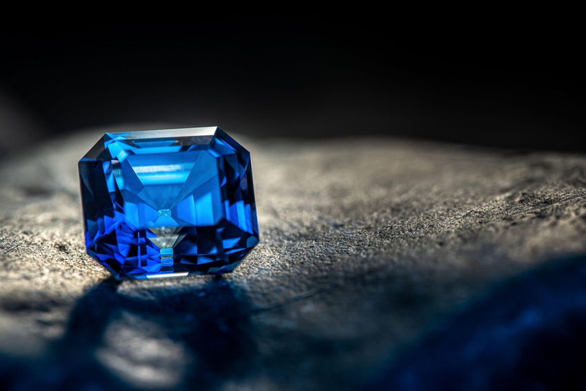 Precious blue sapphire gemstone on dark background