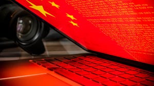 Chinese flag on a laptop screen; camera is next to laptop