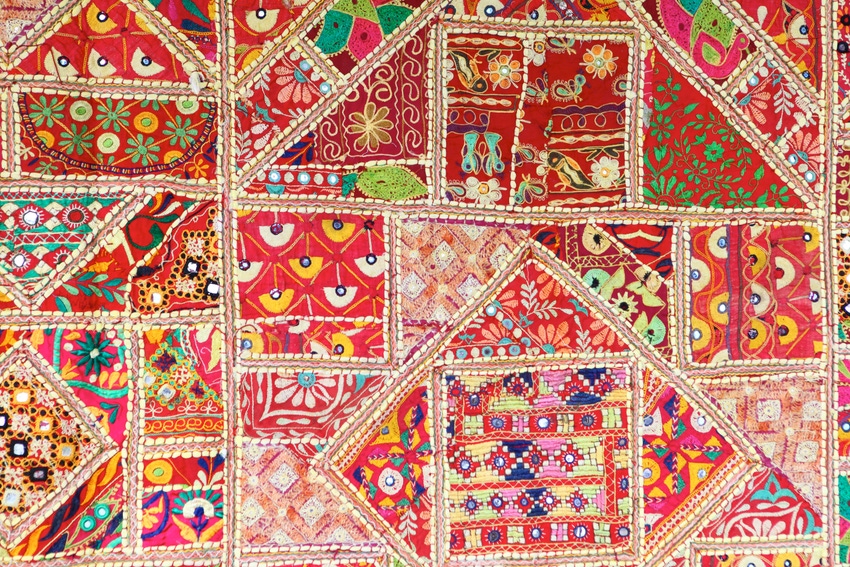 traditional Indian patchwork quilt with reds and oranges