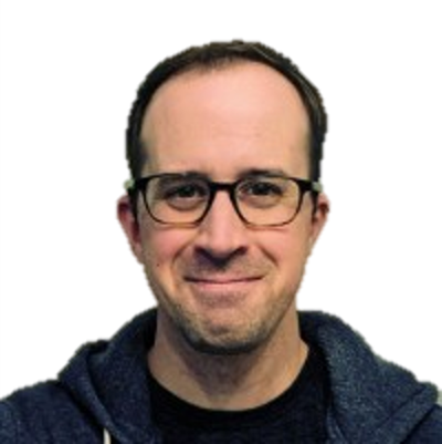 Matt Caulfield, Founder and CEO of Oort, has close-cropped dark hair, dark-framed glasses, a fleece hoodie, and a happy grin