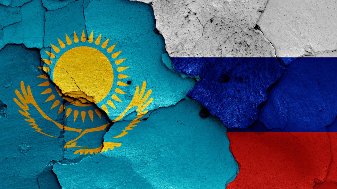 The flags of Kazakhstan and Russia, with a tear down the center The flags of Kazakhstan and Russia, with a tear down the center