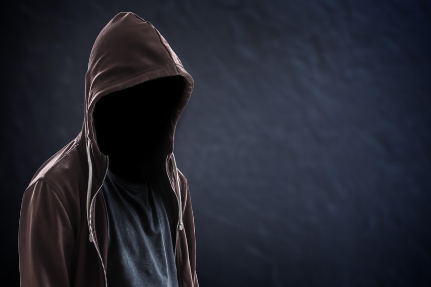 Person in hoodie, dark background