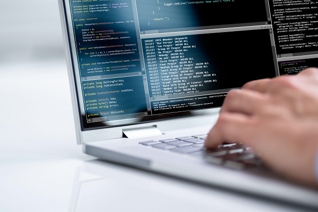 Computer programmer using development software on laptop