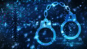 A blue circuit board with handcuffs imposed over it A blue circuit board with handcuffs imposed over it