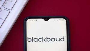 A phone with the Blackbaud company logo on its screen, sitting on a red table
