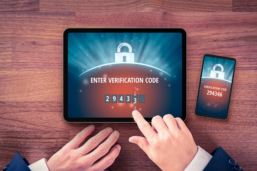 A finger pointing at a screen with a prompt for a verification code needed to log in.