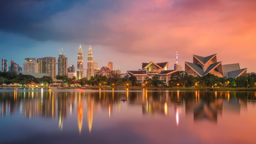 Kuala Lumpur, Malaysia, skyline against the harbor at sunrise