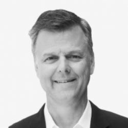 Black-and-white photo of David McNeely, Chief Technology Officer at Delinea, with short hair and a dark jacket